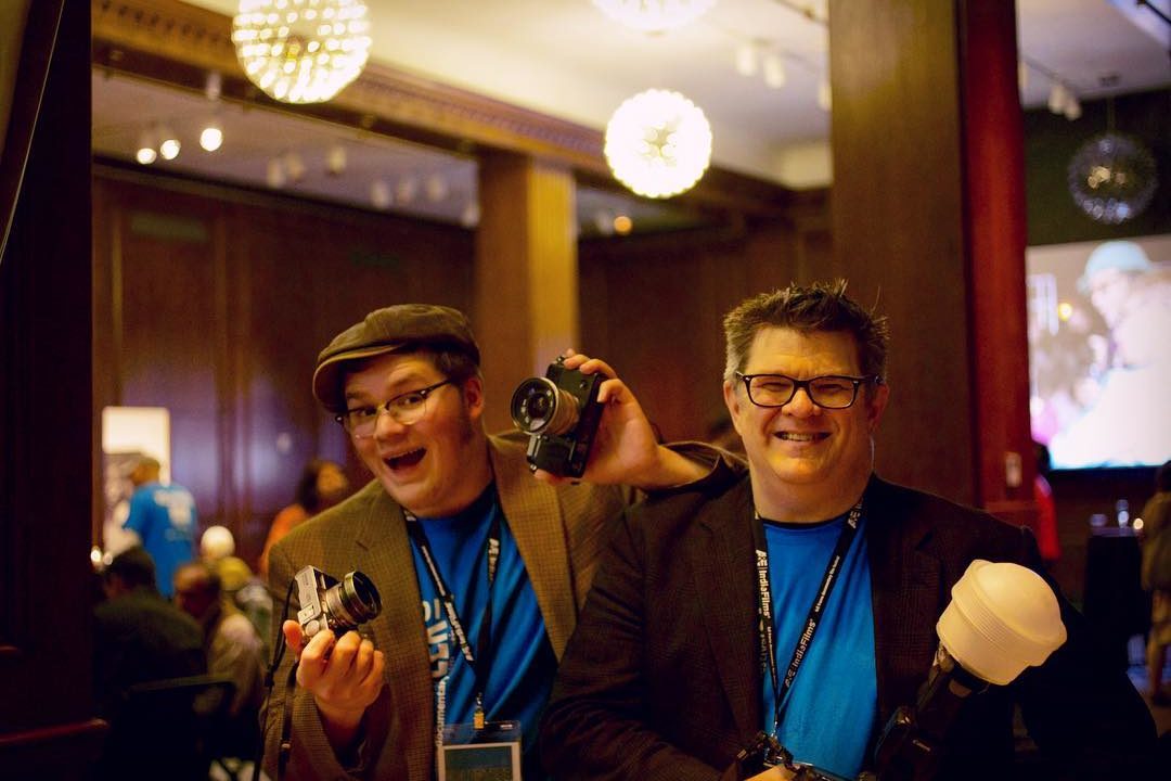 Local photographers Ken & Colin Huth are a dynamic father-son duo!


"We have a pretty nice dance that's second nature now. There's lots of inside jokes and laughter, wedged in around crazy work schedules! At Full Frame, we had that same sort of goofy bond with other volunteers. There we all were, at the last job of the whole festival, and another volunteer pulled us into her maniacal goal of finishing this immense heap of amazing Carolina Theatre popcorn. We ended up roping other photographers - and even some late-arriving guests - into the quest. Silly good times!"